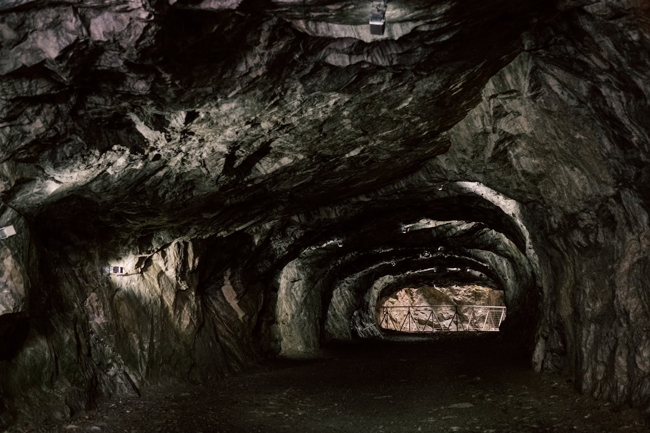 services-bg Explore the mysterious rocky tunnel with natural geological formations.